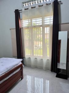 Ένα ή περισσότερα κρεβάτια σε δωμάτιο στο Kinigi Holiday Room