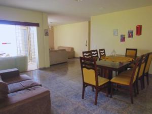 a living room with a table and chairs and a couch at Solar dos Costais in Uberaba