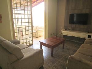 a living room with a couch and a coffee table at Solar dos Costais in Uberaba