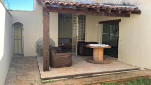 an outdoor patio with a table and a couch at Solar dos Costais in Uberaba