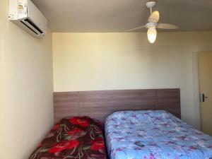 a bedroom with a bed and a ceiling fan at Solar dos Costais in Uberaba