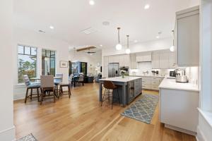 a kitchen and living room with white cabinets and a table at DP2931: 2931 Deer Point in Seabrook Island