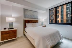 a bedroom with a large bed and two windows at Bluebird Suites at Capitol Hill in Washington +59 photos