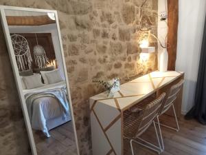 a mirror in a room with a bed and a desk at Casa Rural Arlanza 13 in Arlanza