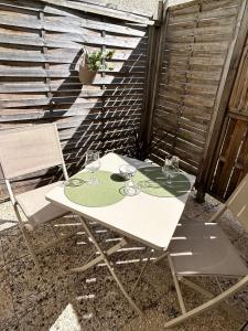 a white table and chairs on a patio at Charmant studio avec terrasse in Fécamp