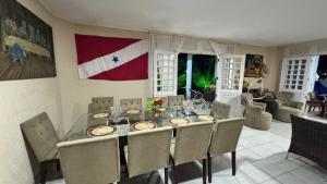 a dining room with a table with a flag on the wall at Casa do Lago Salinópolis in Salinópolis