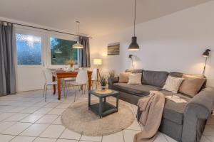 a living room with a couch and a table at Ferienwohnung Erdgeschoss in Fehmarn