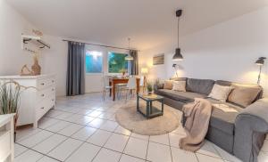 a living room with a couch and a table at Ferienwohnung Erdgeschoss in Fehmarn