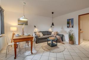 a living room with a couch and a table at Ferienwohnung Erdgeschoss in Fehmarn