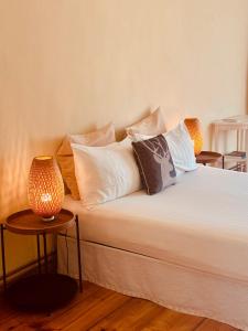 a bed with pillows and a lamp on it at Al Cavour 34 in Trento