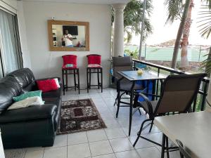a living room with a couch and a table and chairs at Lovely 2 bedroom condo with pool in Marigot