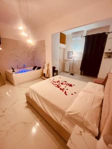 a bedroom with a large white bed with red flowers on it at Nuvola Luxury suite in Turin