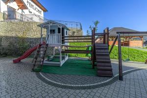 a playground with a ladder and a slide at Pensjonat Perła Pienin in Grywałd