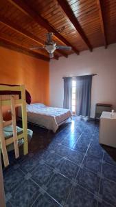 a bedroom with a bed and a ceiling at Posada Ruta 65 in General Fernández Oro