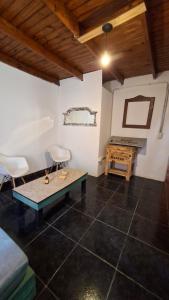 a living room with a table and a desk at Posada Ruta 65 in General Fernández Oro