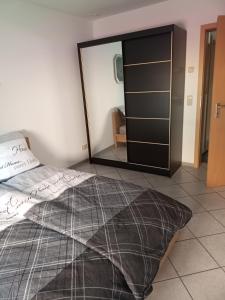 a bedroom with a bed and a large mirror at FEWO Caro in Nordhausen