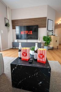 a table with some drinks on it in a living room at Modernes Apartment - Basel, Kur & Golf in Bad Bellingen