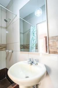 a bathroom with a sink and a mirror at Hotel Suite Los Inkas en Arequipa in La Pampilla