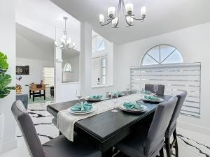 een eetkamer met een zwarte tafel en stoelen bij Casita mi Encanto a Cozy & Spacious House, 4-bedroom 3-Bath & pool in Kissimmee