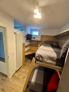a bedroom with two bunk beds and a flat screen tv at Fiore delle Alpi in Bellamonte +11 photos