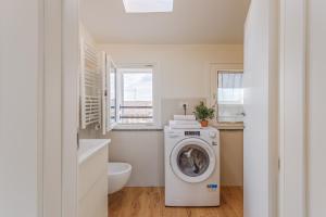 a bathroom with a washing machine and a sink at Corso Adriano 13 - La Torre in Modena