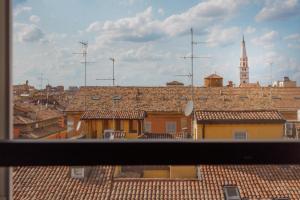 a view from a window of a city with roofs at Corso Adriano 13 - La Torre in Modena
