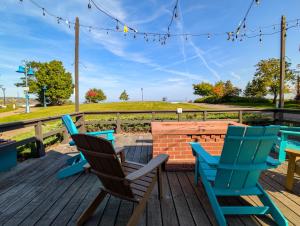 a deck with chairs and a table and a brick wall at Endion Station Inn by Heirloom Boutique Collection in Duluth