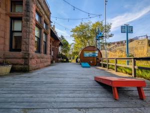 a red bench on a boardwalk next to a building at Endion Station Inn by Heirloom Boutique Collection in Duluth