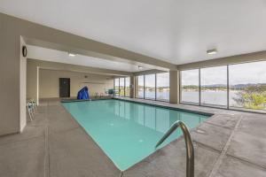a large swimming pool in a building with windows at Best Western Pier Point Inn in Florence