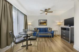 a living room with a blue couch and a table at Best Western Pier Point Inn in Florence