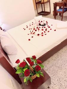 a bed with a bunch of red roses on it at Vang Vieng Ruby Villa Hotel in Vang Vieng
