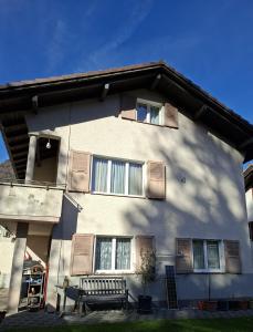 Un edificio con un banco delante de él. en Anna's Appartement, en Matten