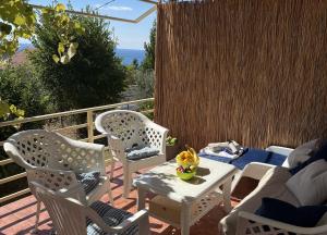 a patio with chairs and a table and a couch at Summer house Kruce in Kruče +25 photos