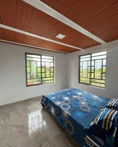 a bedroom with a bed in a room with windows at Villa Verde in Popayan +14 photos
