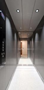 a hallway of a building with a walkway and a door at Apartament Podniebny z Windą in Kluczbork