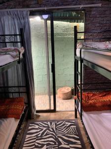 a room with two bunk beds and a window at Ewakanda Backpackers in Vereeniging