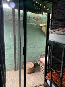 a room with two bunk beds and a brick wall at Ewakanda Backpackers in Vereeniging