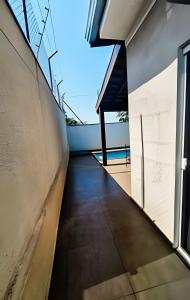 a hallway of a house with a window at Casa confortável com piscina e área para churrasco in Sao Jose do Rio Preto