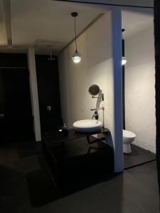 a bathroom with a sink and a toilet at Serenity Room at Villa Love in Seminyak +22 photos