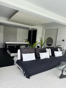 a living room with a black and white couch at Serenity Room at Villa Love in Seminyak