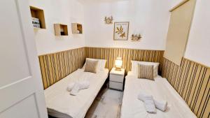 two beds in a room with wooden walls at Skyview Apartment in Adeje +31 photos