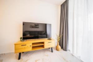 a living room with a television on a wooden dresser at Skyview Apartment in Adeje