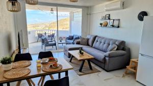 a living room with a couch and a table at Skyview Apartment in Adeje