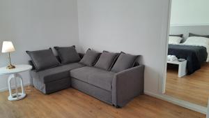 a living room with a couch and a bed at Antica Dimora Petito Luxury Suites in Matera +48 photos