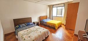 a bedroom with two beds and a window at Casa del Pino in Popayan +7 photos