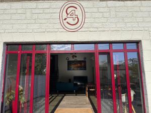 a building with red doors and a sign on it at maison chaleureuse ,avec piscine, spa, Futuroscope in Jaunay-Marigny