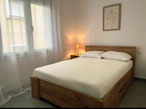 a bedroom with a large bed with a window at HomeBak Hospitality in Xanthi