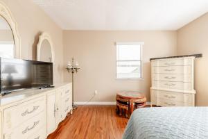 a bedroom with a bed and a flat screen tv at Welcome to Your Serene Waterfront Getaway! in Cocoa