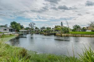 a river with a dock in the middle at Welcome to Your Serene Waterfront Getaway! in Cocoa