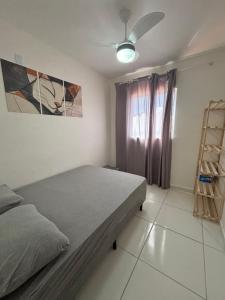 a bedroom with a bed and a ceiling fan at Casa Delta 187 in Parnaíba